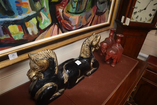 A Chinese carved wood horse group and a pair of lacquered elephant candlesticks